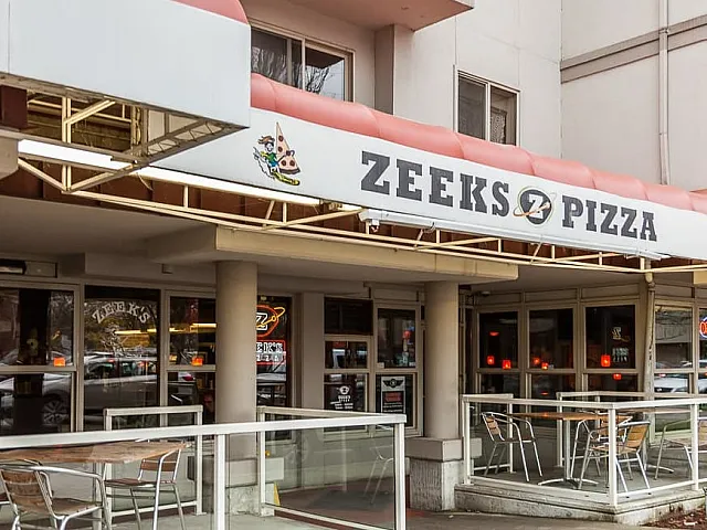 Inviting outdoor seating at a bustling pizza restaurant, showcasing a vibrant atmosphere with modern decor.
