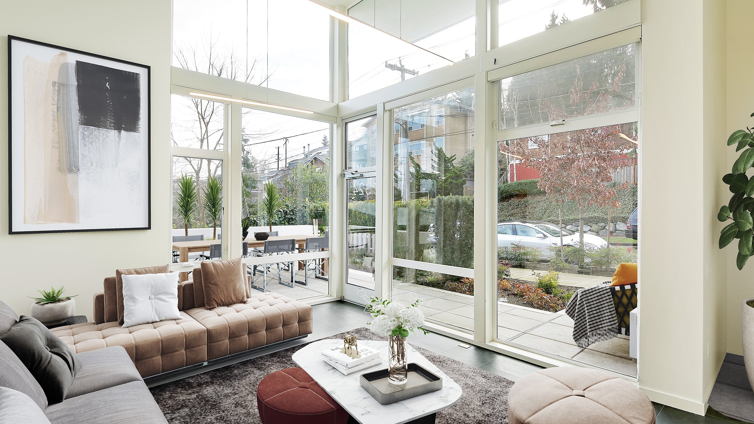 Stunning contemporary living room with floor-to-ceiling windows, lush outdoor view, chic seating, and elegant decor accents.