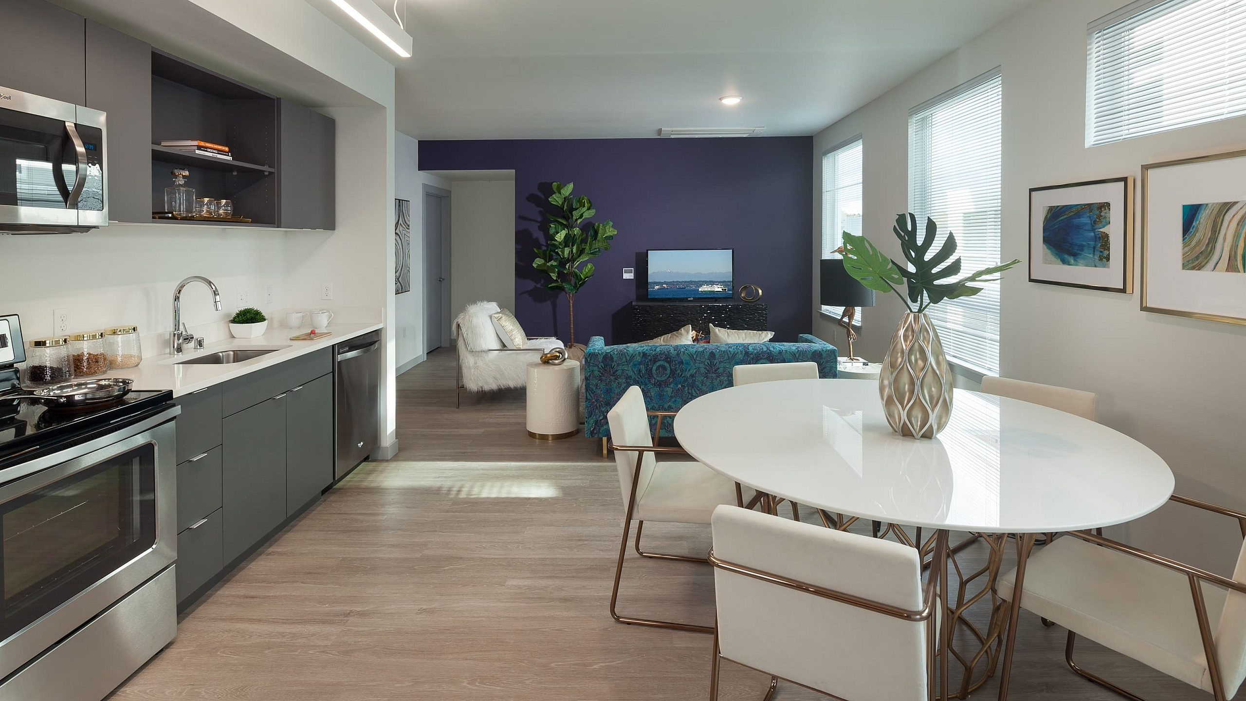 Modern open-concept apartment with sleek kitchen, elegant dining area, and cozy living room featuring stylish decor.