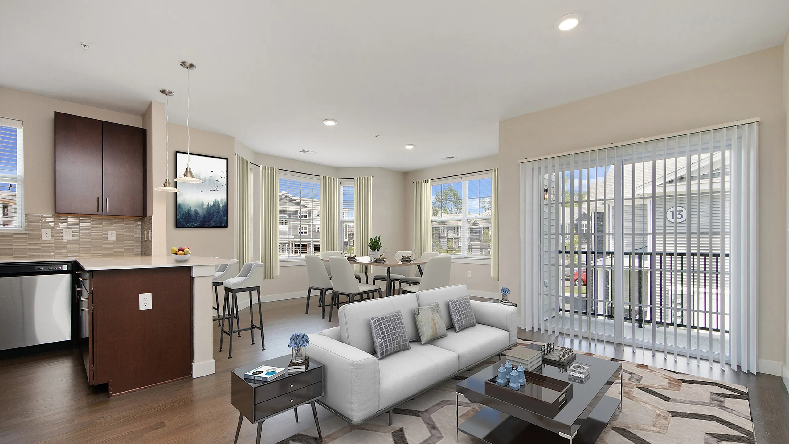 Modern open-concept living area with stylish decor, featuring a cozy sofa, elegant dining set, and a sleek kitchen with contemporary finishes.