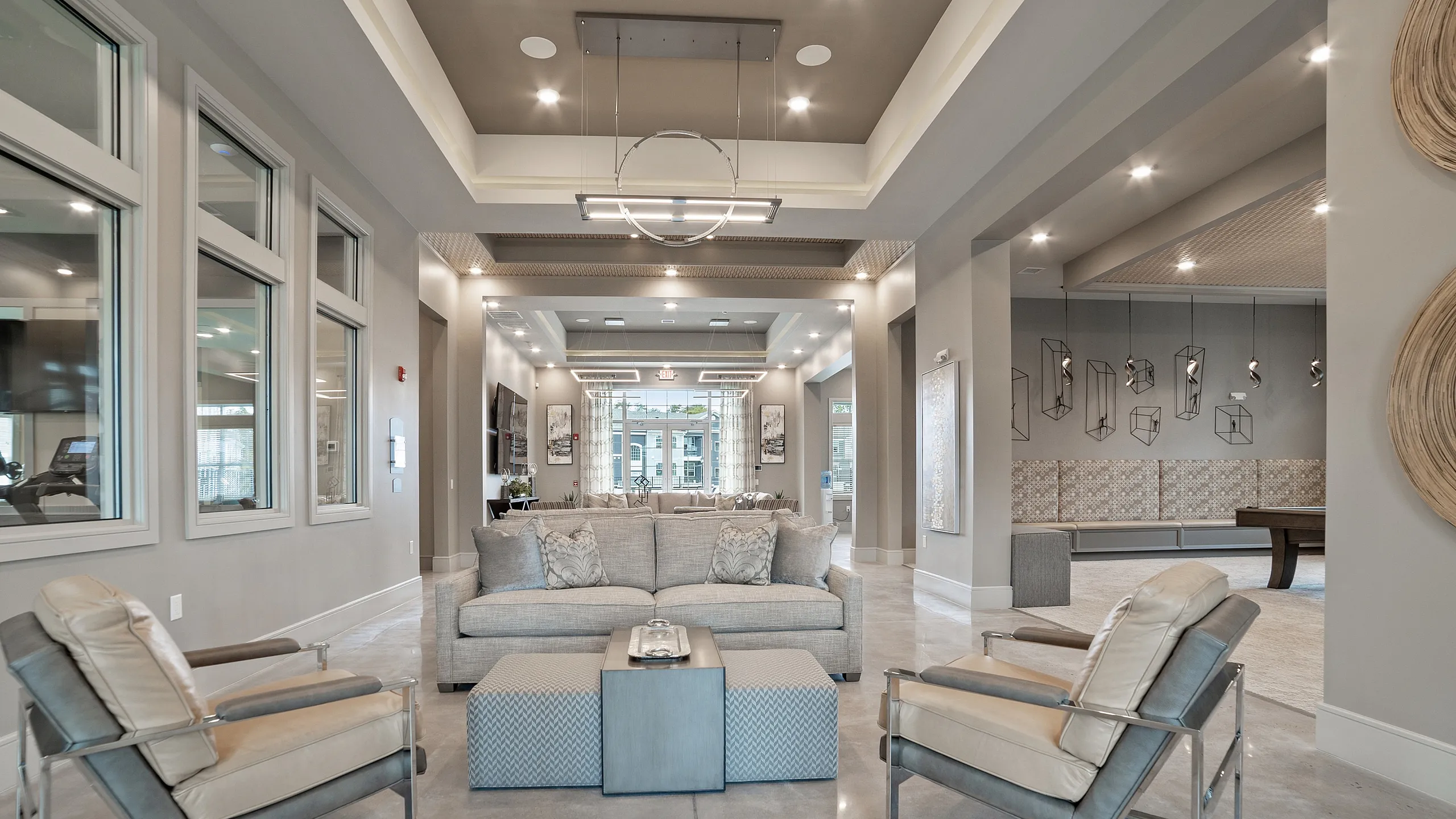 Sophisticated apartment lounge with modern decor, plush seating, and elegant lighting, perfect for relaxation and social gatherings.