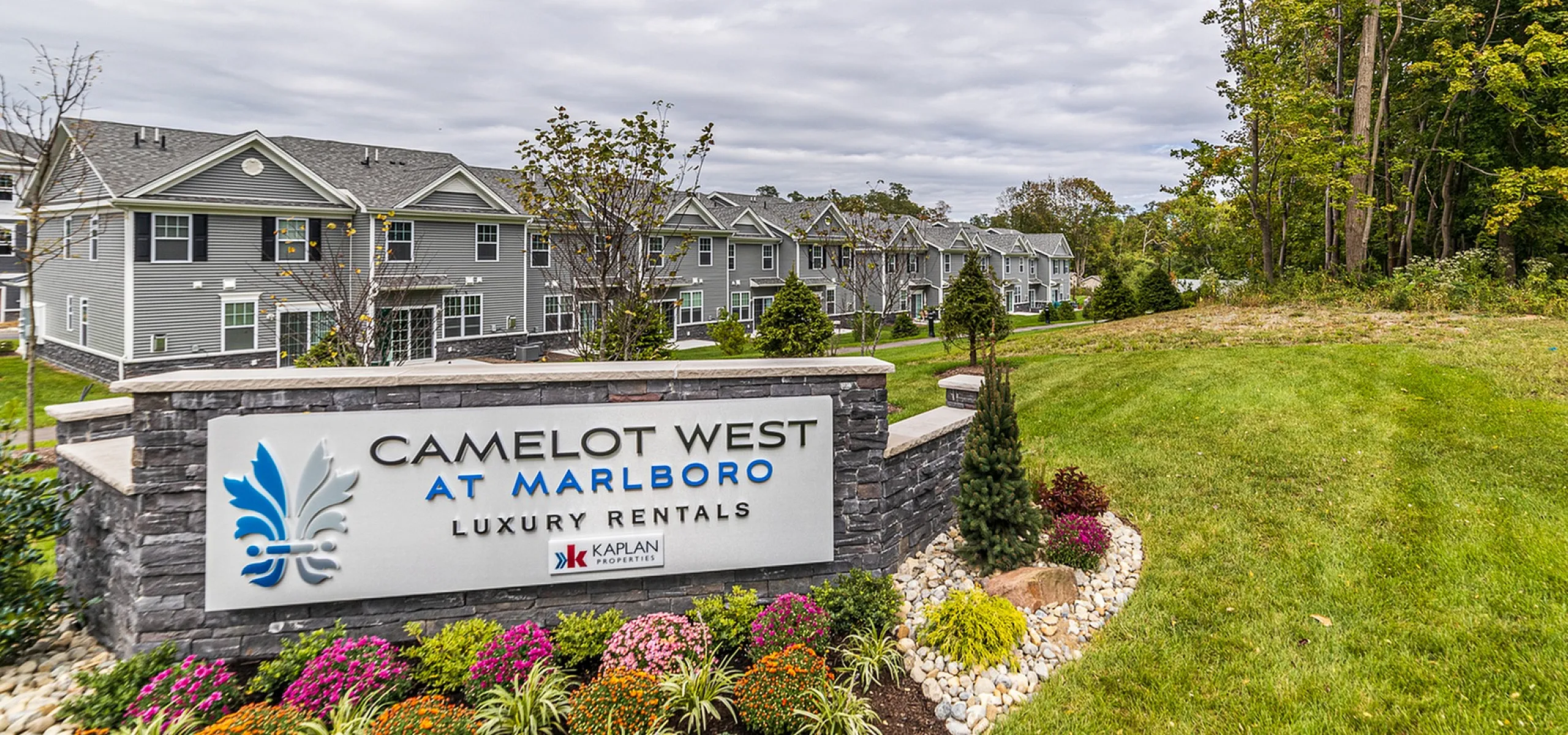 Charming residential complex at Camelot West, Marlboro, featuring modern townhouses and beautifully landscaped gardens.