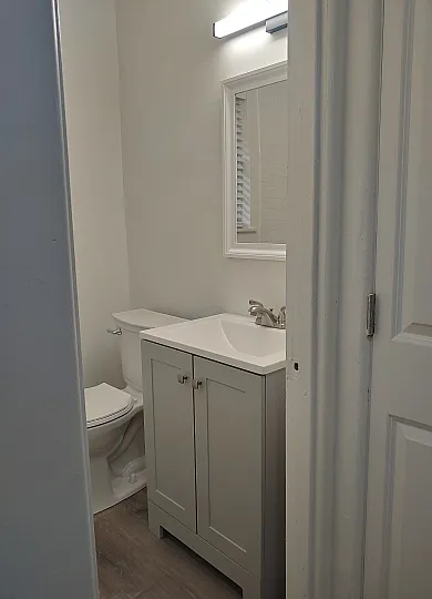 Chic and modern bathroom with stylish vanity, elegant fixtures, and a cozy, well-lit ambiance.