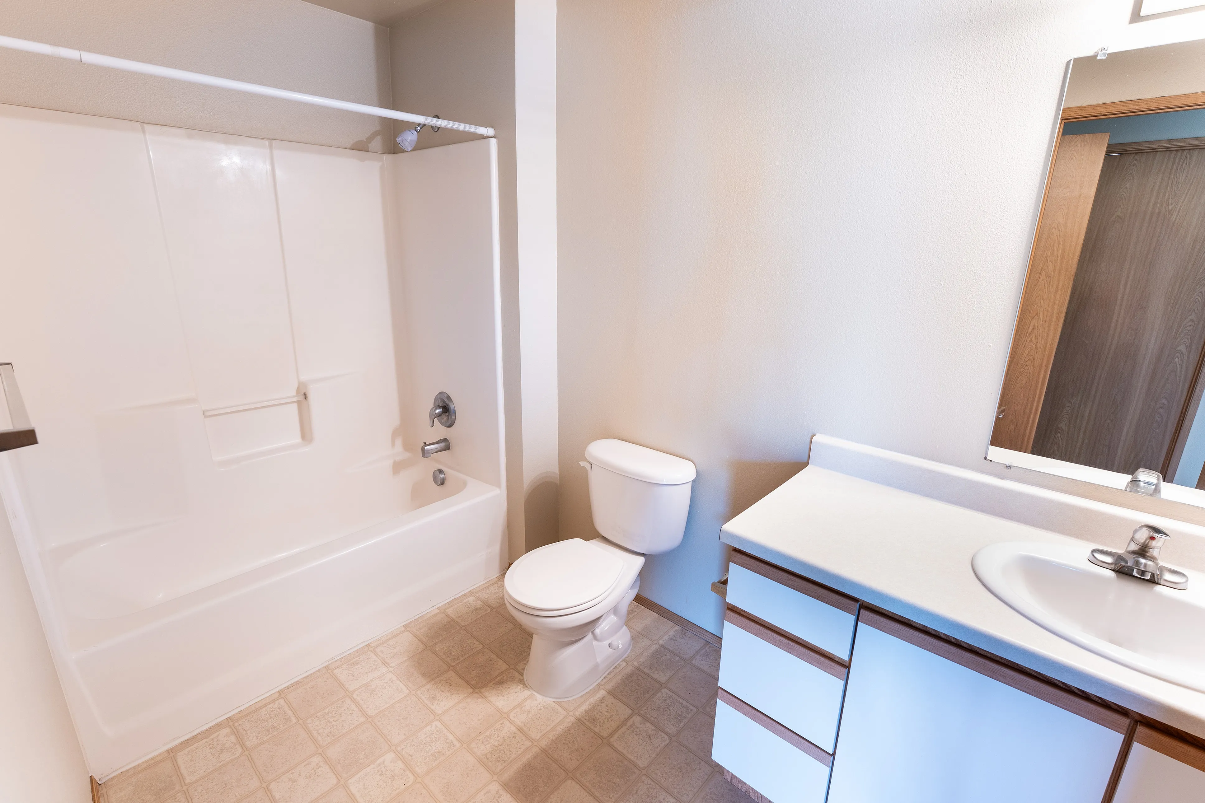 Bright, modern bathroom with sleek fixtures featuring a full bathtub, elegant sink, and ample counter space.