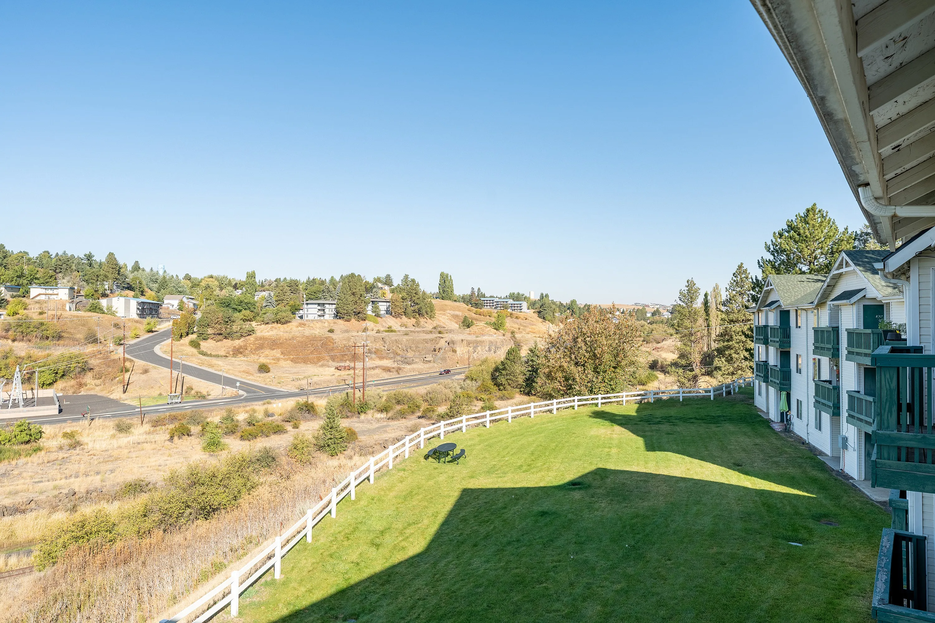 Stunning view of lush green lawns and a scenic countryside, perfect for tranquil apartment living with easy access to nature.