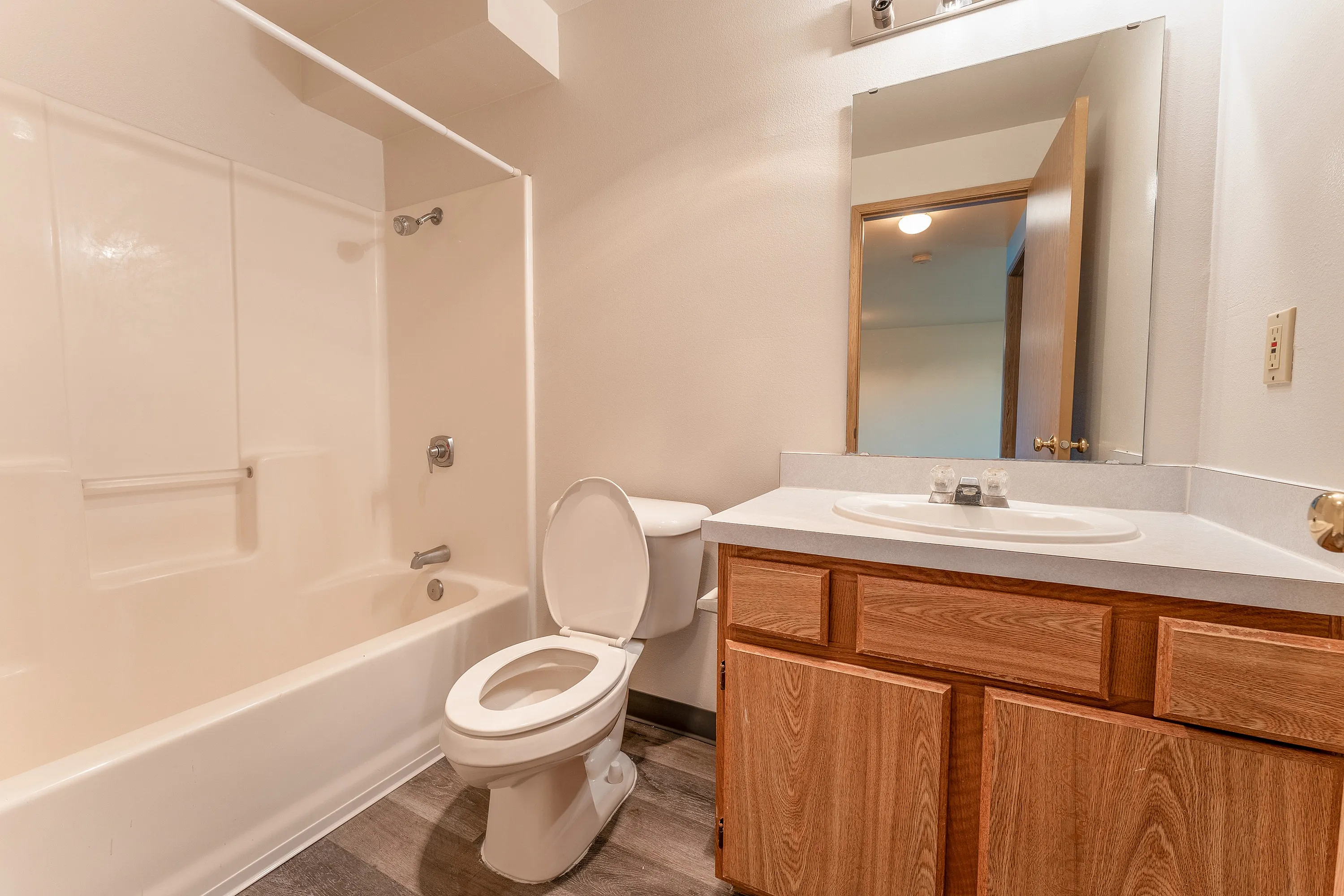 Bright, modern bathroom featuring a sleek bathtub, elegant vanity with ample storage, and contemporary fixtures.