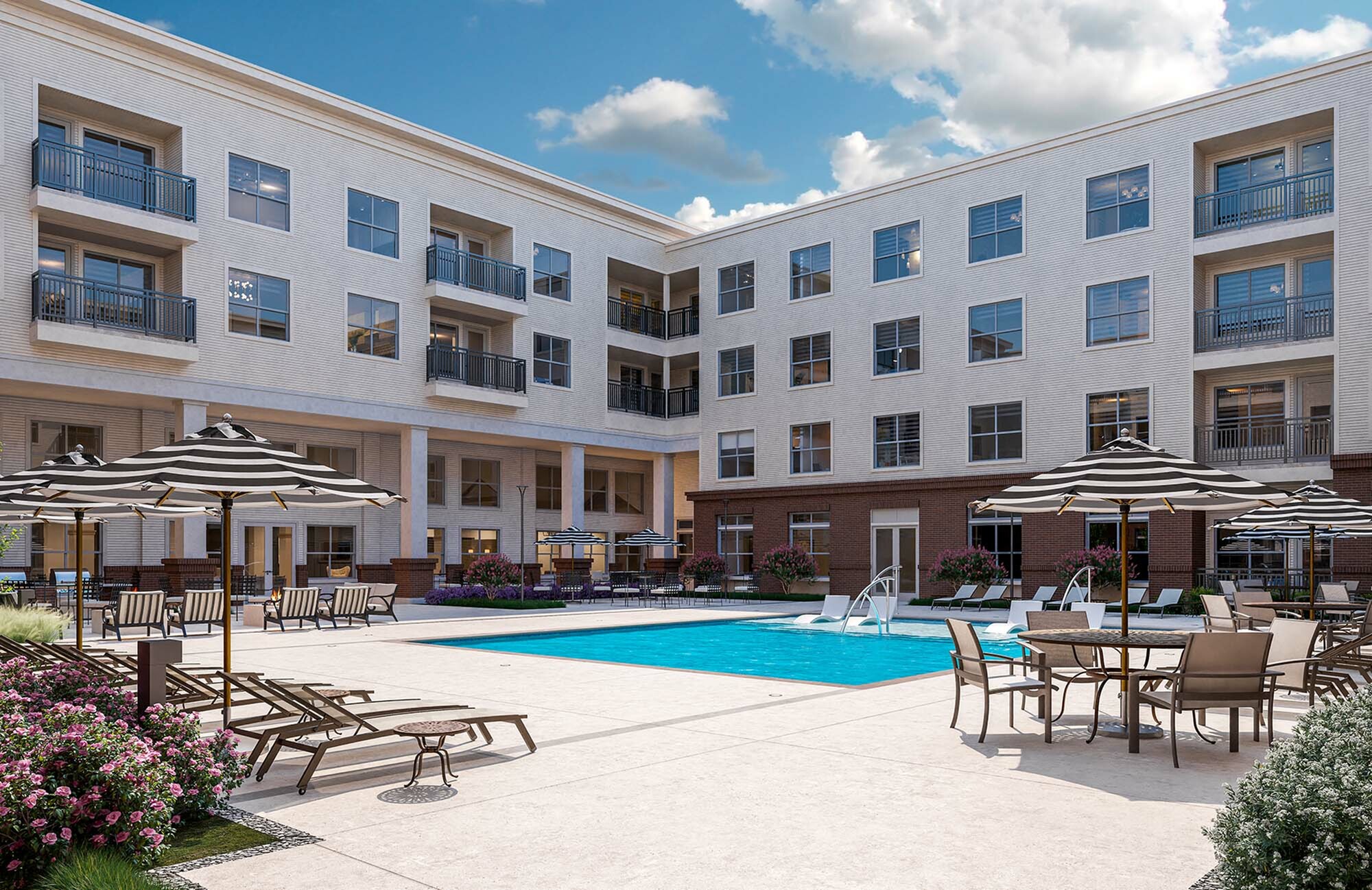 Chic apartment complex featuring a spacious outdoor pool area with stylish lounge seating and umbrellas.