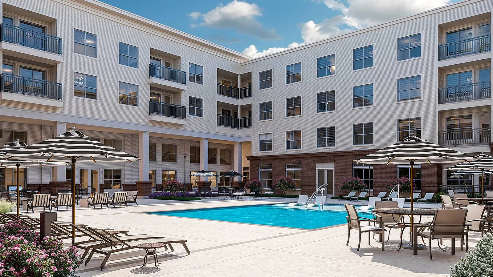 Inviting pool area surrounded by stylish lounge chairs and umbrellas in a modern apartment complex.