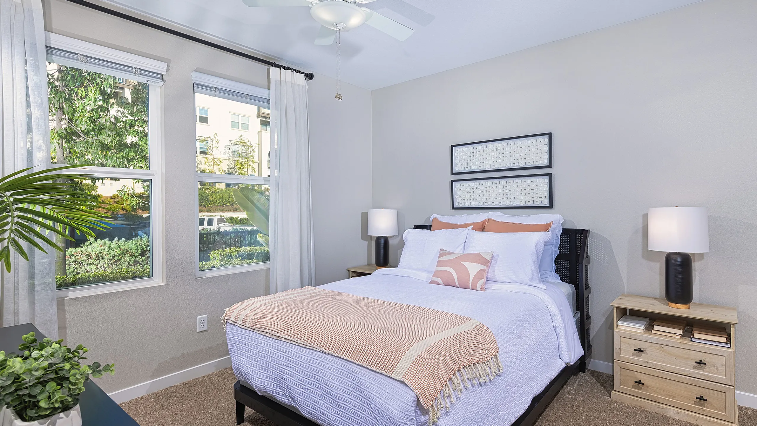 Cozy bedroom with a queen-sized bed, large windows offering natural light, and elegant decor for a peaceful retreat.