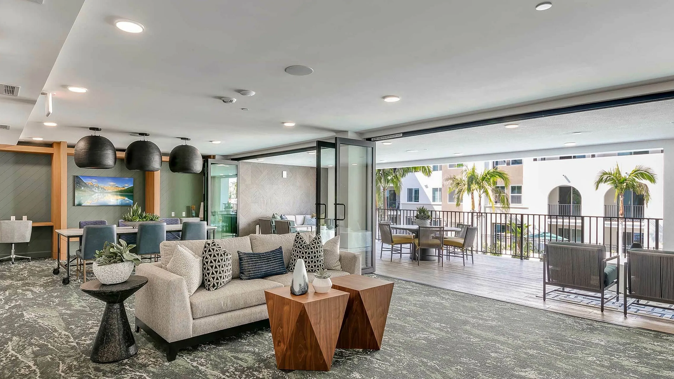 Luxurious open-concept amenity space with modern furniture, vibrant decor, and expansive balcony views.