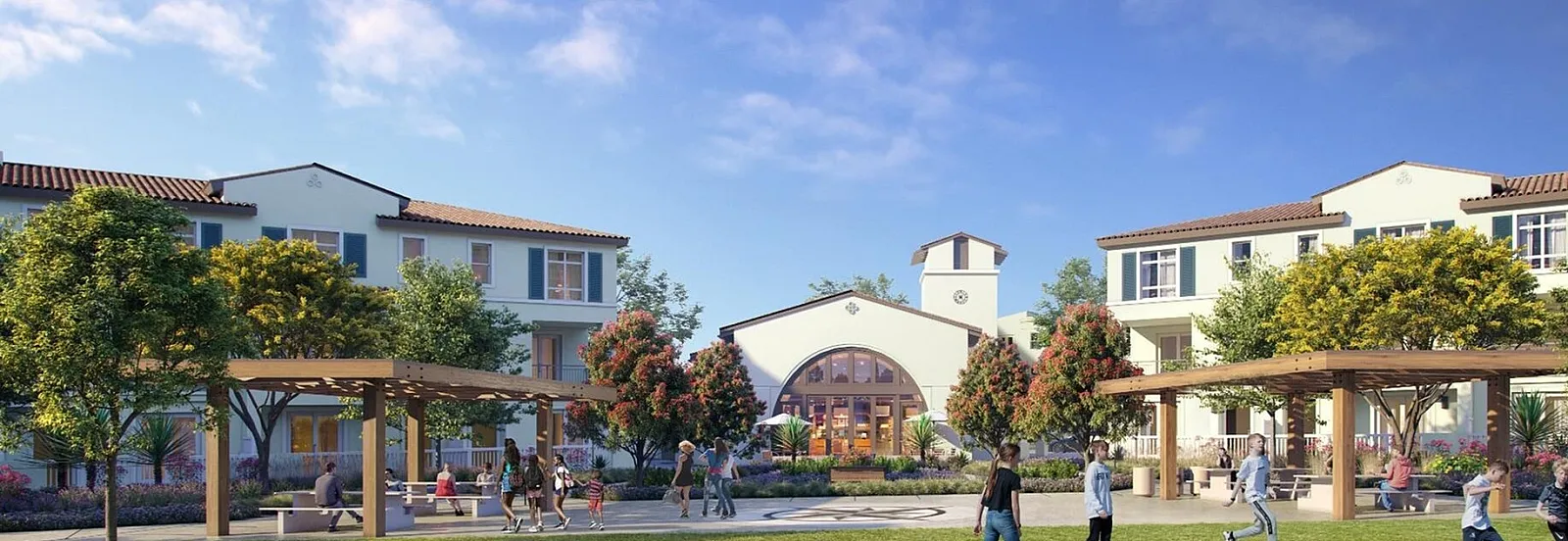 Charming luxe townhome rental featuring lush green space, vibrant landscaping, and welcoming community areas under clear blue skies.