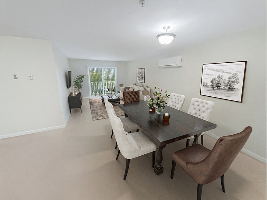 Elegant dining area with a chic dark wood table and plush chairs, opening into a bright living room with artful decor and a view of the outdoors.
