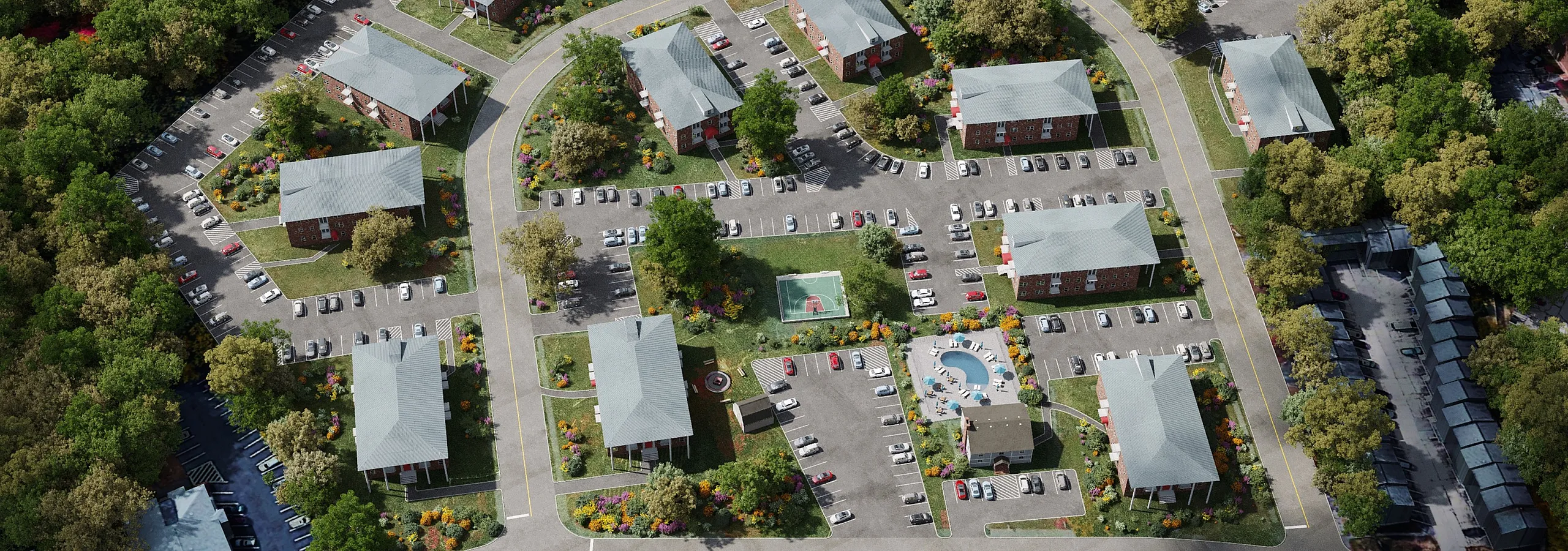 Aerial view of a serene apartment complex nestled in lush greenery, featuring multiple modern buildings, ample parking, and a central swimming pool surrounded by landscaped gardens.