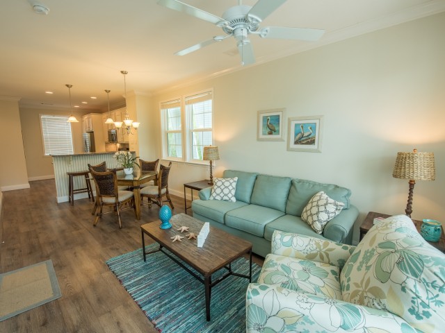 Furnished open-concept living room with ceiling fan, dining room and kitchen