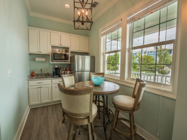 Dinette set in kitchen with upgraded lighting and stainless steel microwave and refrigerator