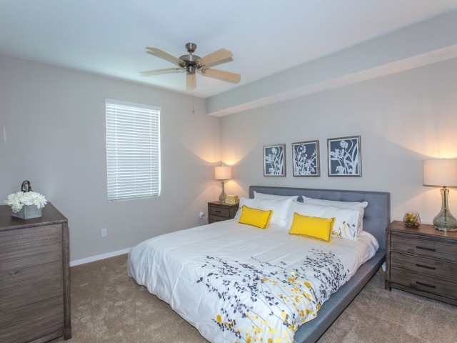 Spacious Bedroom with ceiling fan, large bed with two bed-side tables l High Ridge Landing