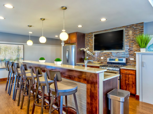 Image of Sophisticated community room including: chef's catering kitchen, double-sided fireplace, pool and poker tables for Wheaton 121 Apartments (Closed)