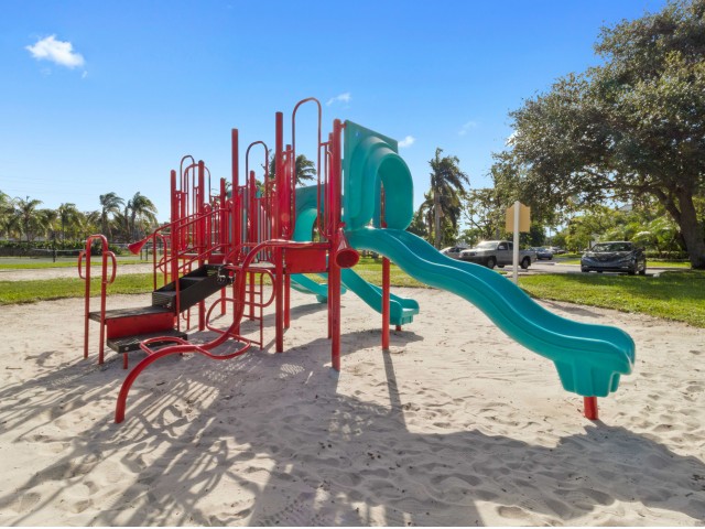 Playground with climbing apparatuses and slides on sand