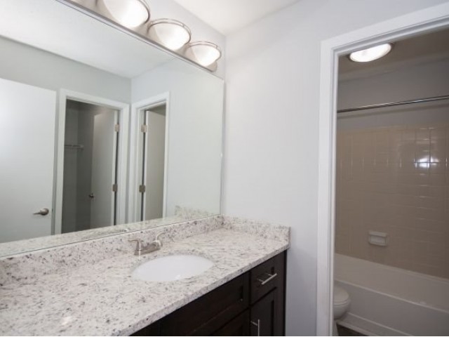 Bathroom with white granite countertops