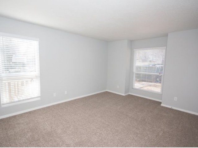 carpeted bedroom with grey walls and white trim