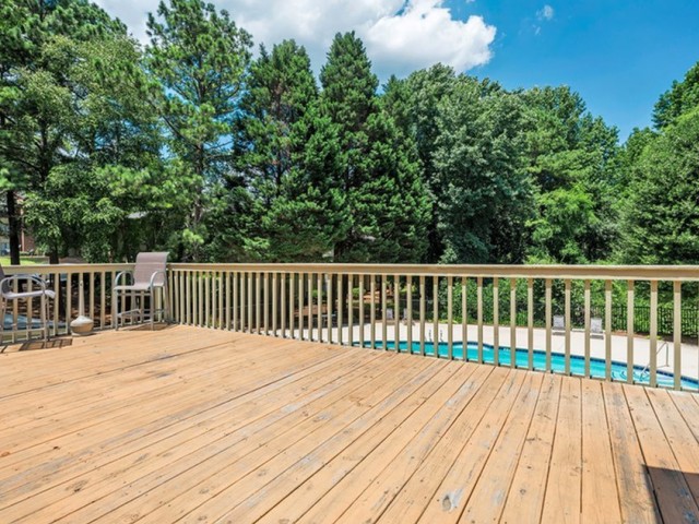 sundeck overlooking the pool surrounded by trees