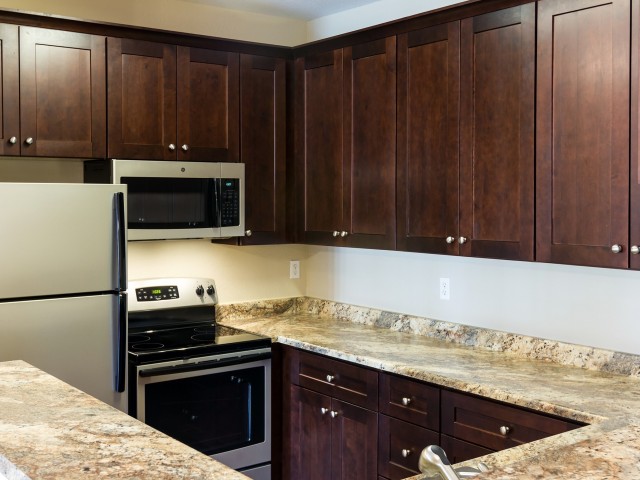 kitchen with granite countertops and microwave