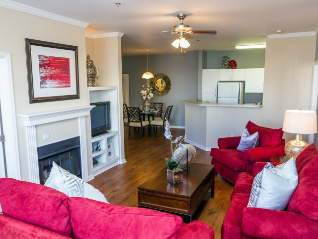 interior model home with fireplace and large couches