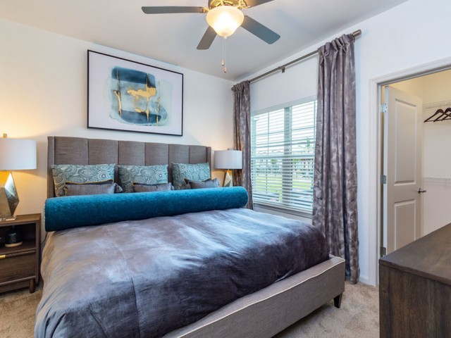 Treviso Grand Apartments - North Venice, Florida master bedroom with walk in closet and ceiling fan