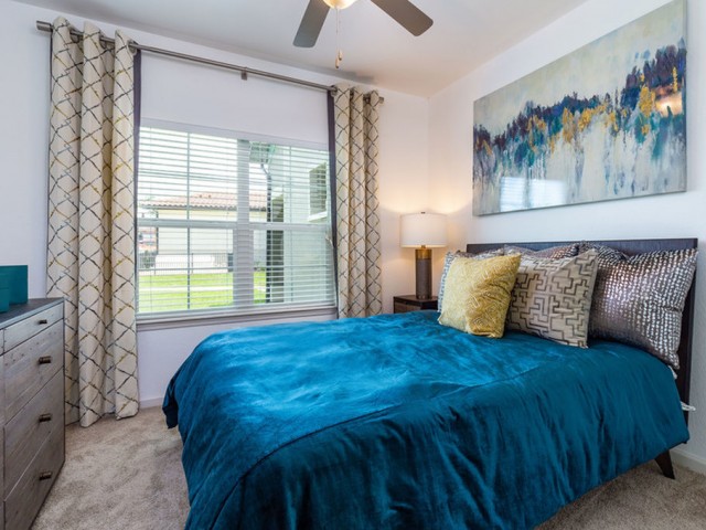 Treviso Grand Apartments - North Venice, Florida bedroom with ceiling fan and carpet