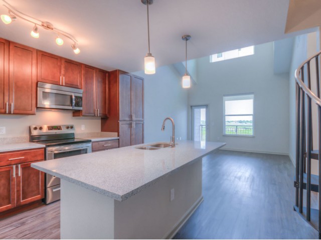 San Mateo Apartments Kissimmee Florida kitchen with adjacent living room and spiral stairs