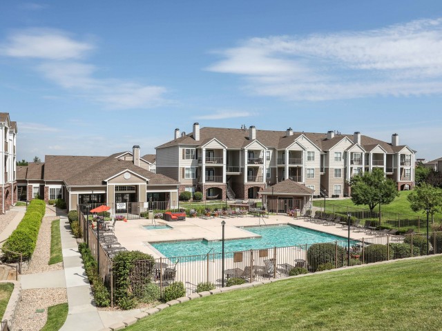 grassy hill looking down at pool and clubhouse