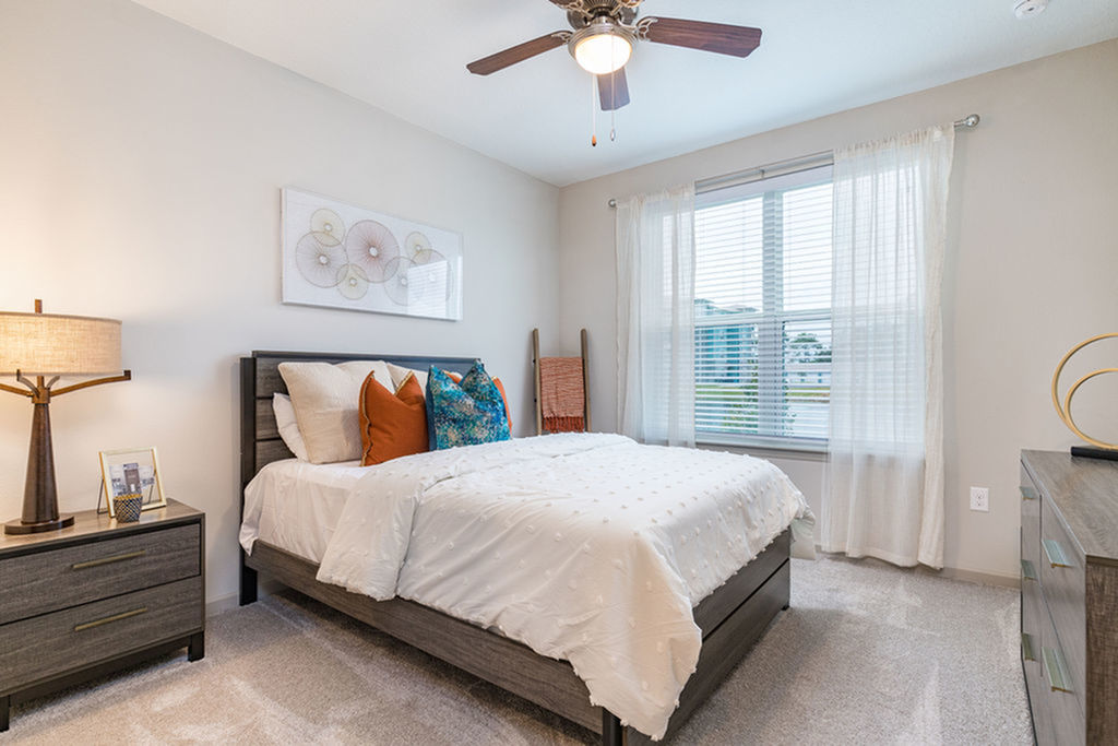 San Mateo Apartments Kissimmee Florida bedroom with carpeted floors and ceiling fan