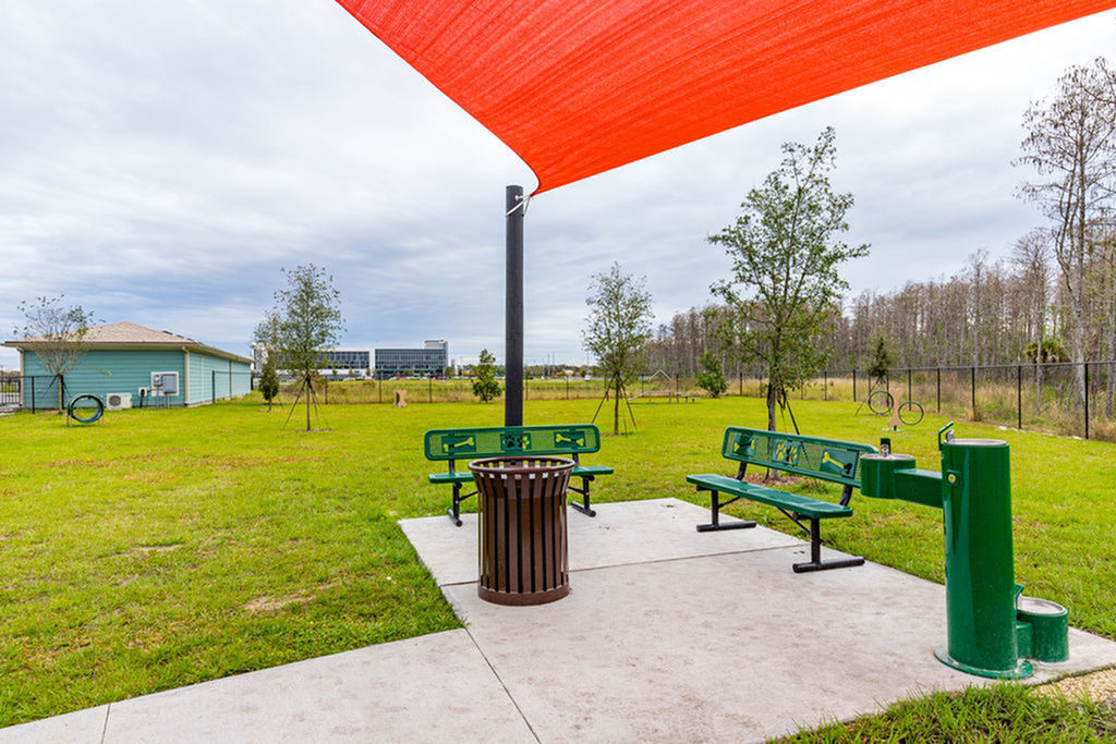 San Mateo Apartments Kissimmee Florida outdoor pet park with agility equipment, benches and water fountain