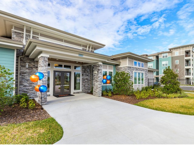 San Mateo Apartments Kissimmee Florida community clubhouse entry way by manicured landscaping