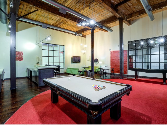 Interior view of resident lounge with billiard table and indoor shuffleboard table