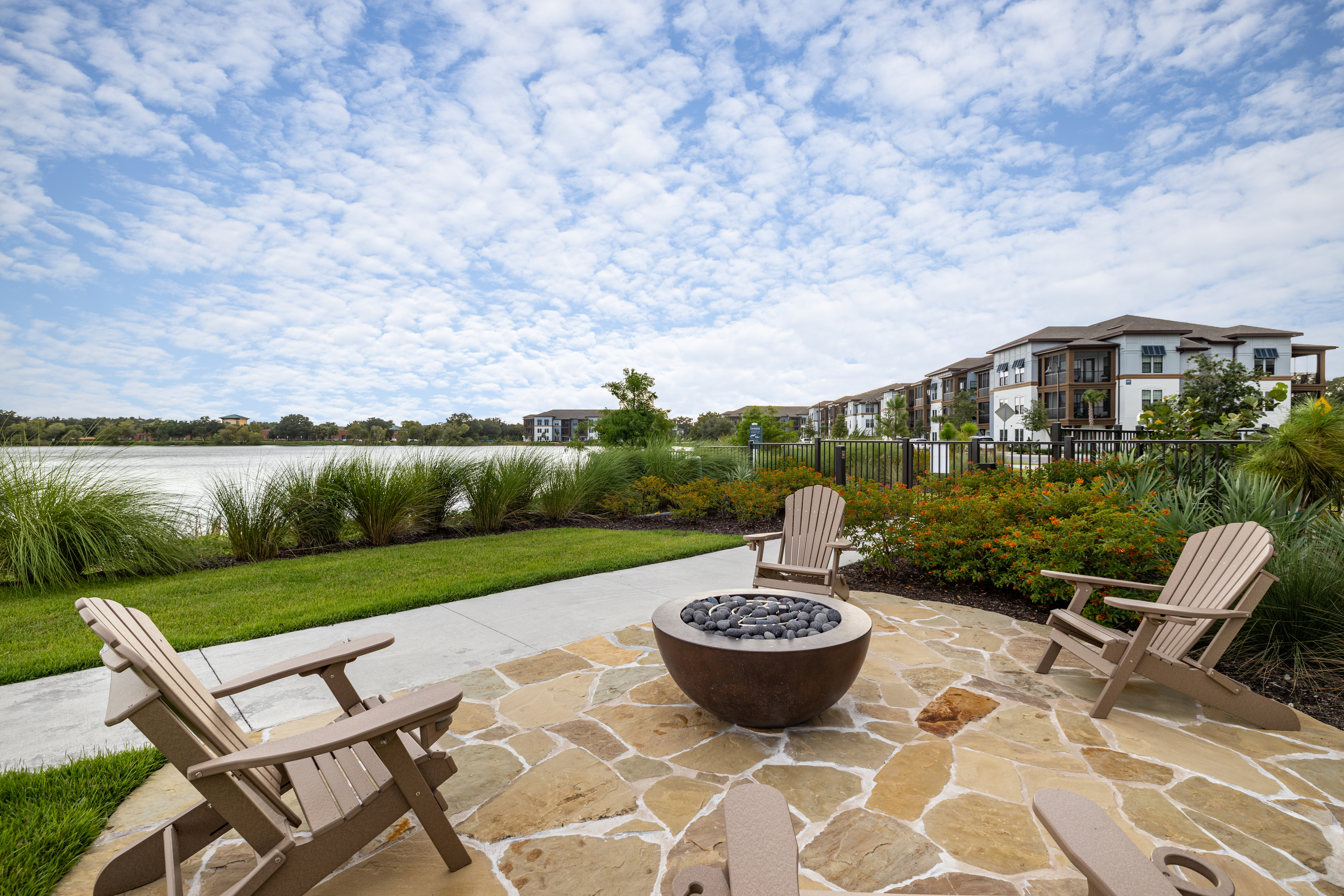 Ridgelake | Seating Area Next to Lake with Building in Background