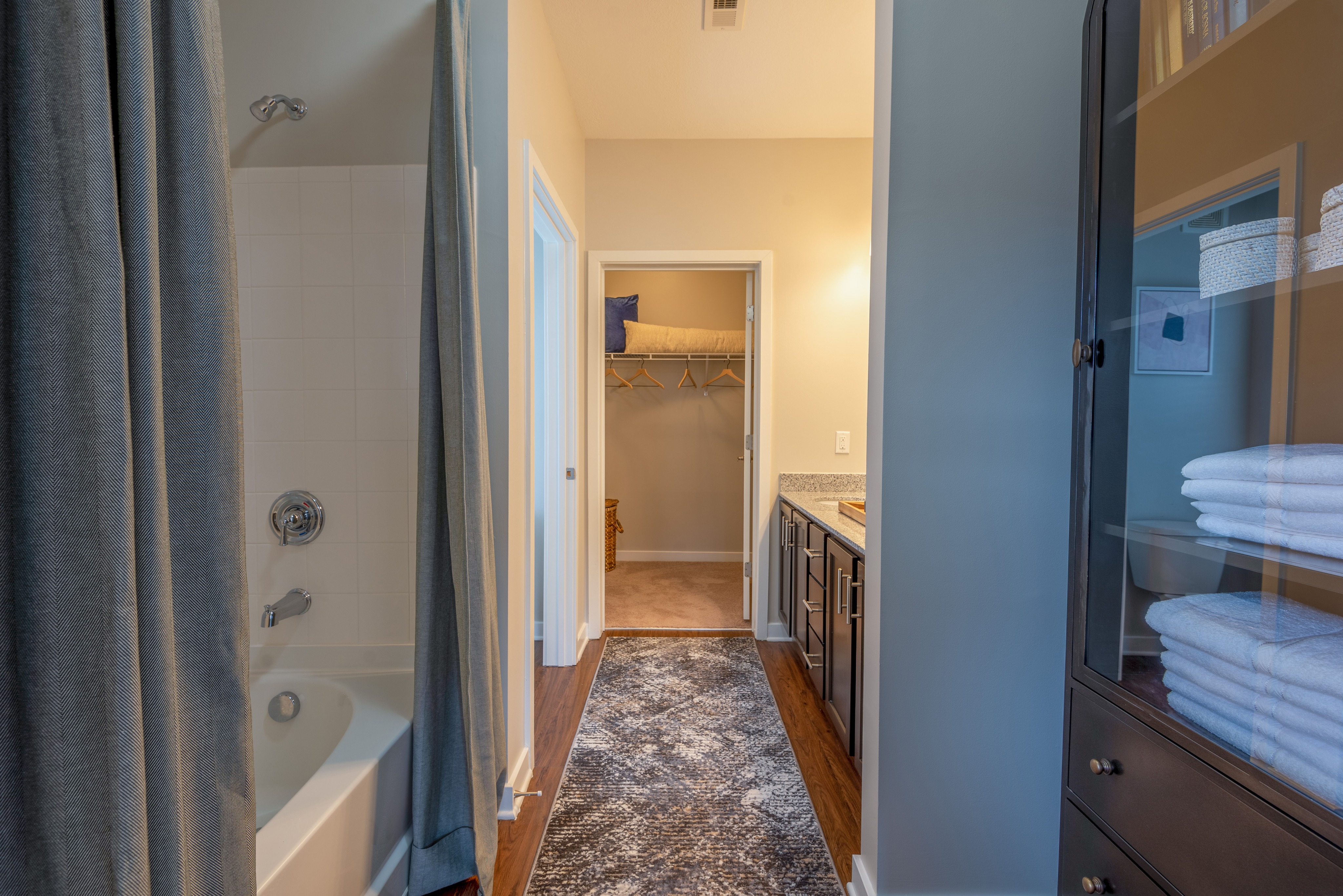 Furnished model master bathroom with access to walk in closet
