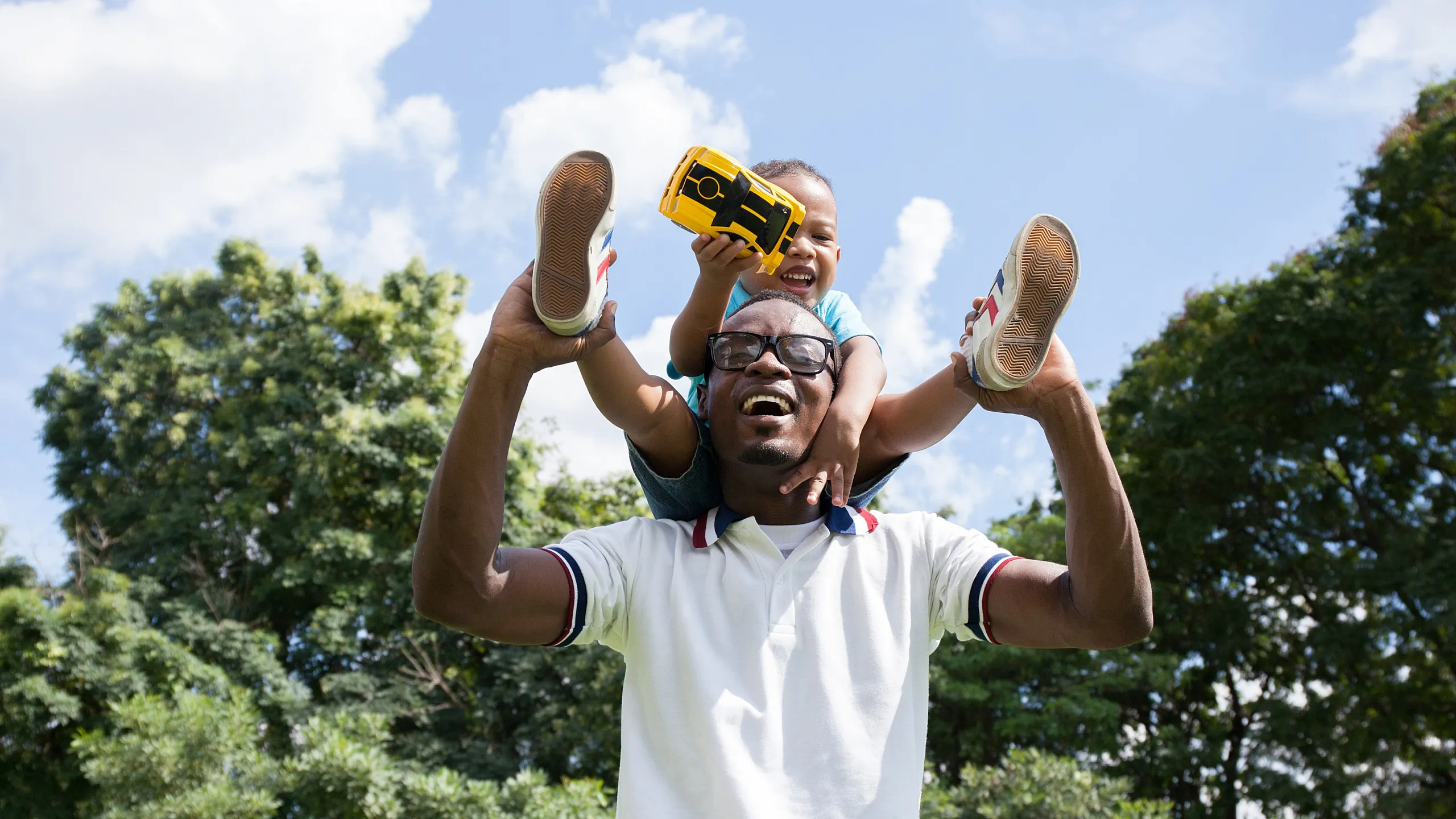 Baby and father outside playing