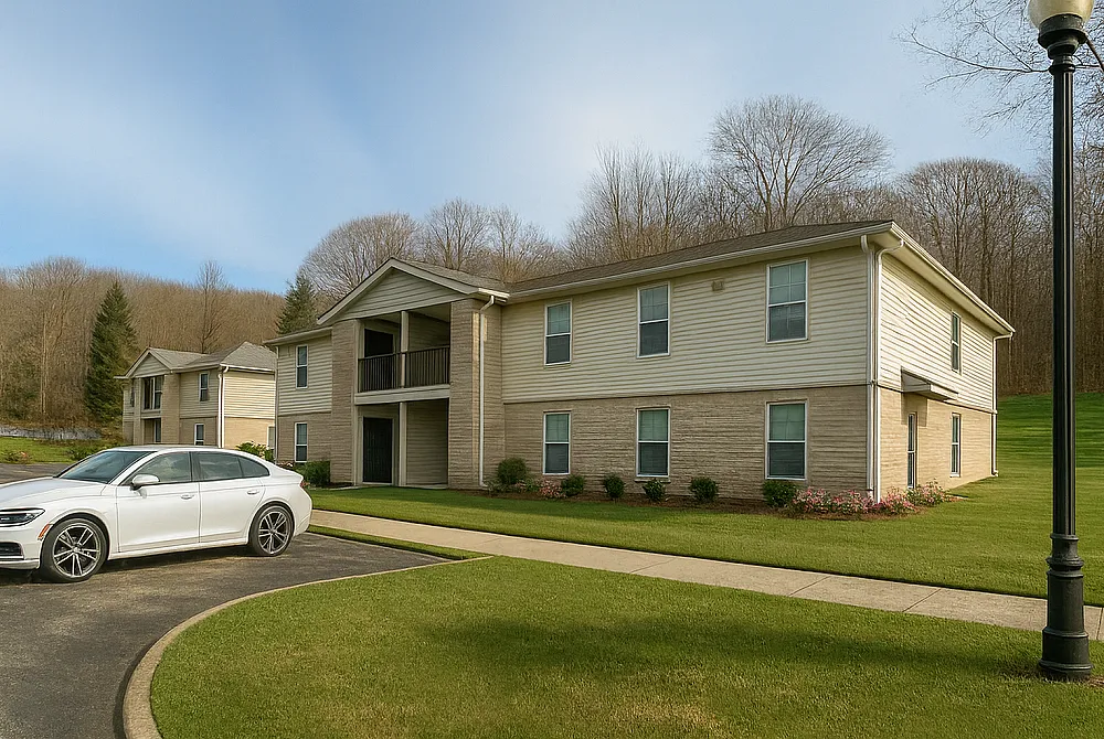 Charming two-story apartment building with well-maintained landscaping and ample parking in a serene, natural setting.