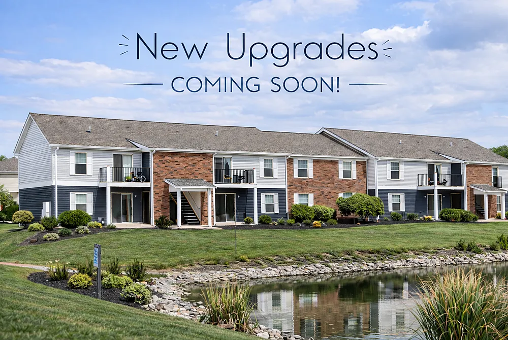 Charming apartment complex with modern upgrades, featuring lush landscaping and serene pond views.