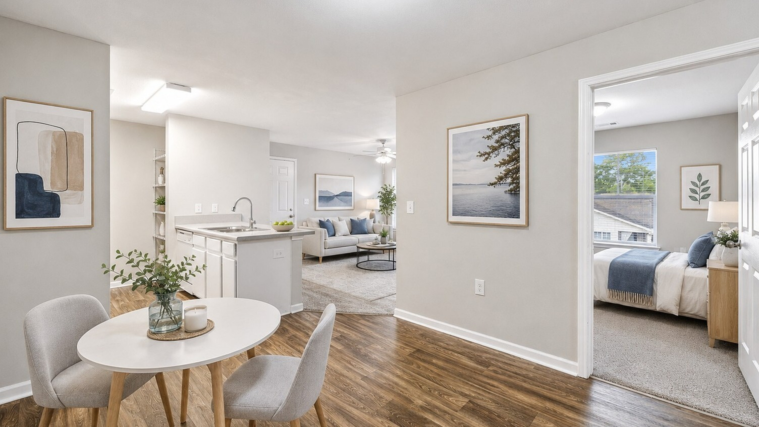 Bright and inviting apartment interior showcasing an open-plan kitchen, dining area, and a cozy living room with stylish decor and modern furnishings.