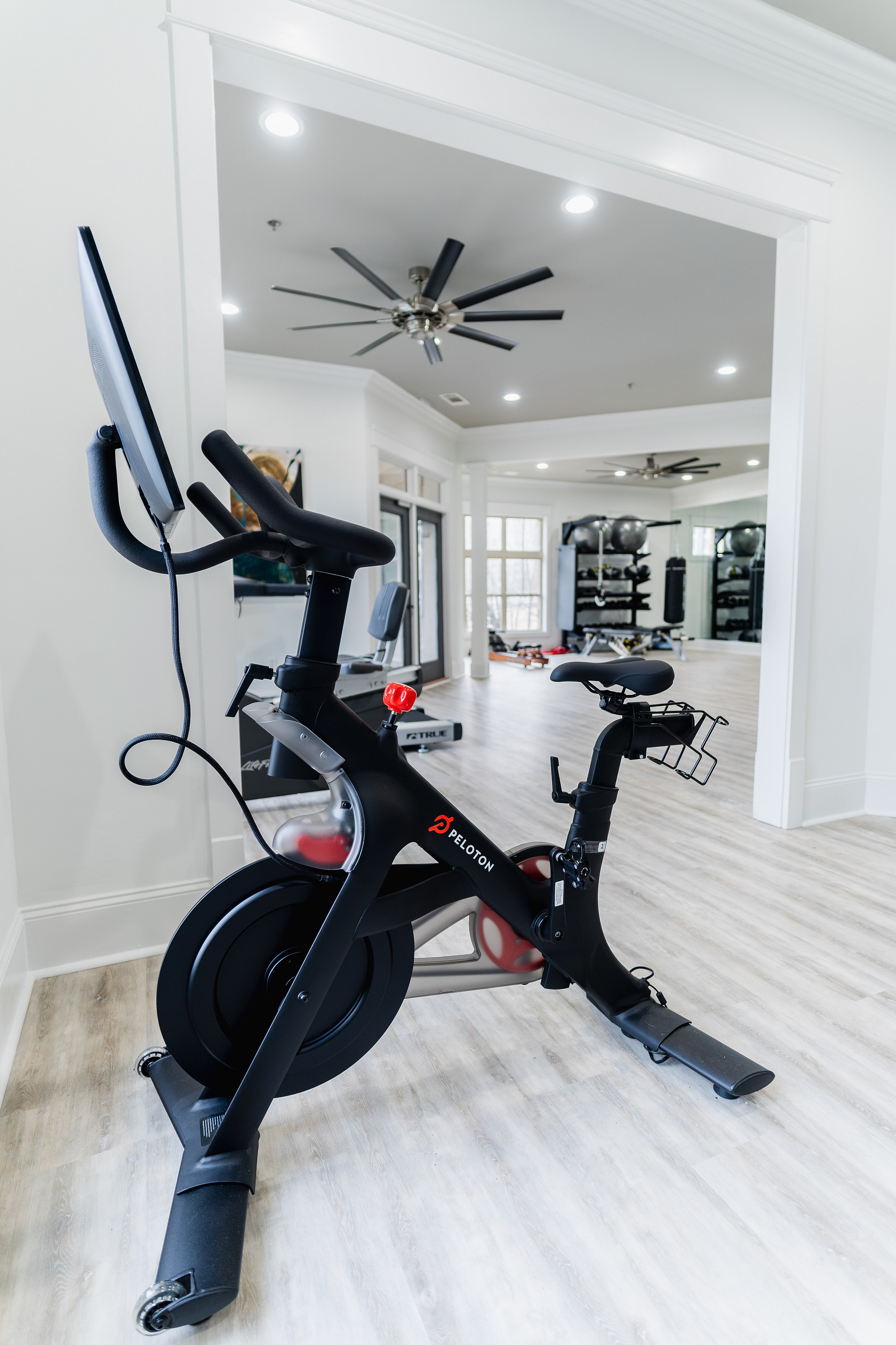 Modern fitness room with sleek exercise bikes, spacious layout, and ample natural light.