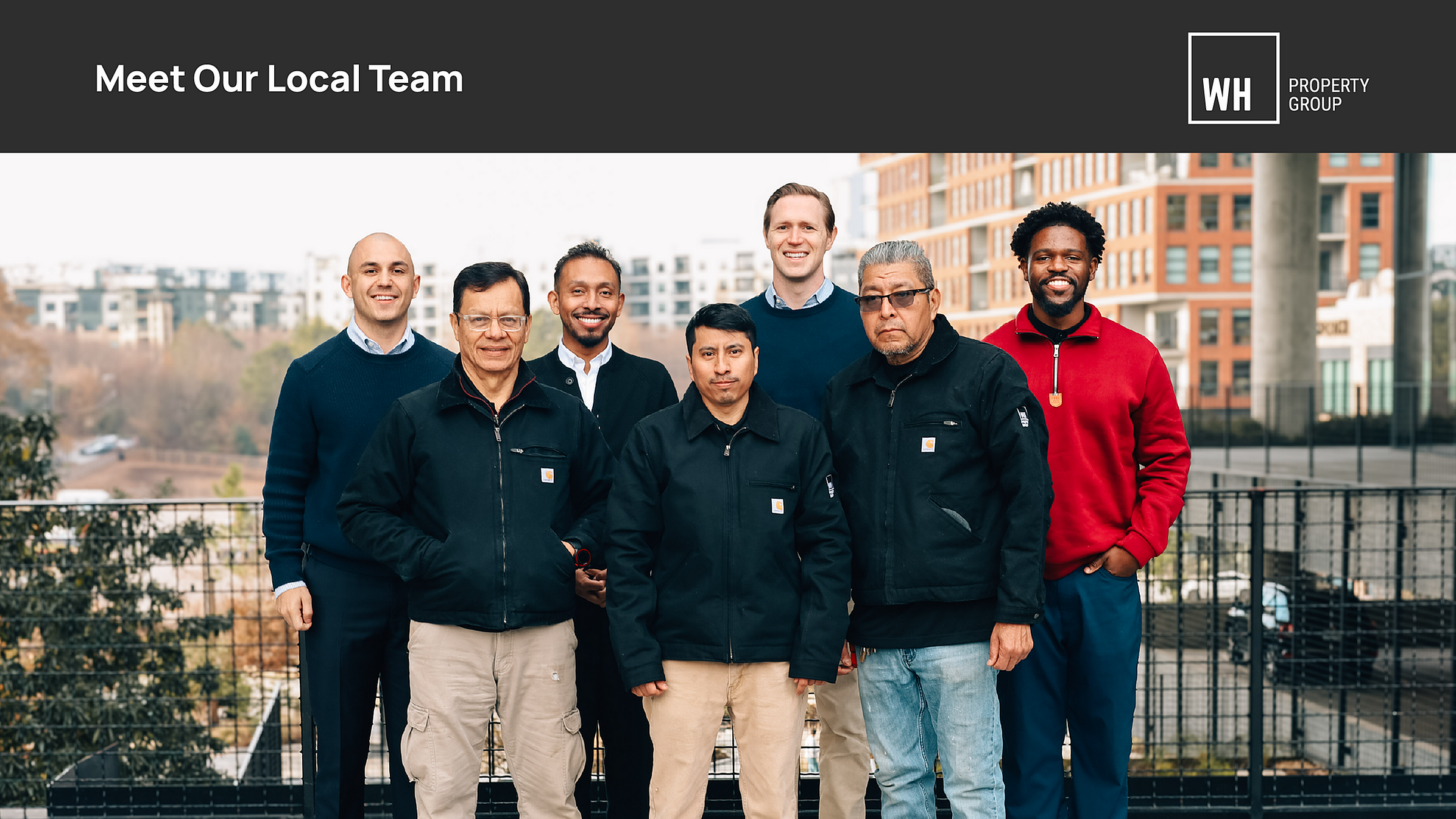 Vibrant local team of professionals posing outdoors with modern architecture in the background, representing WH Property Group.
