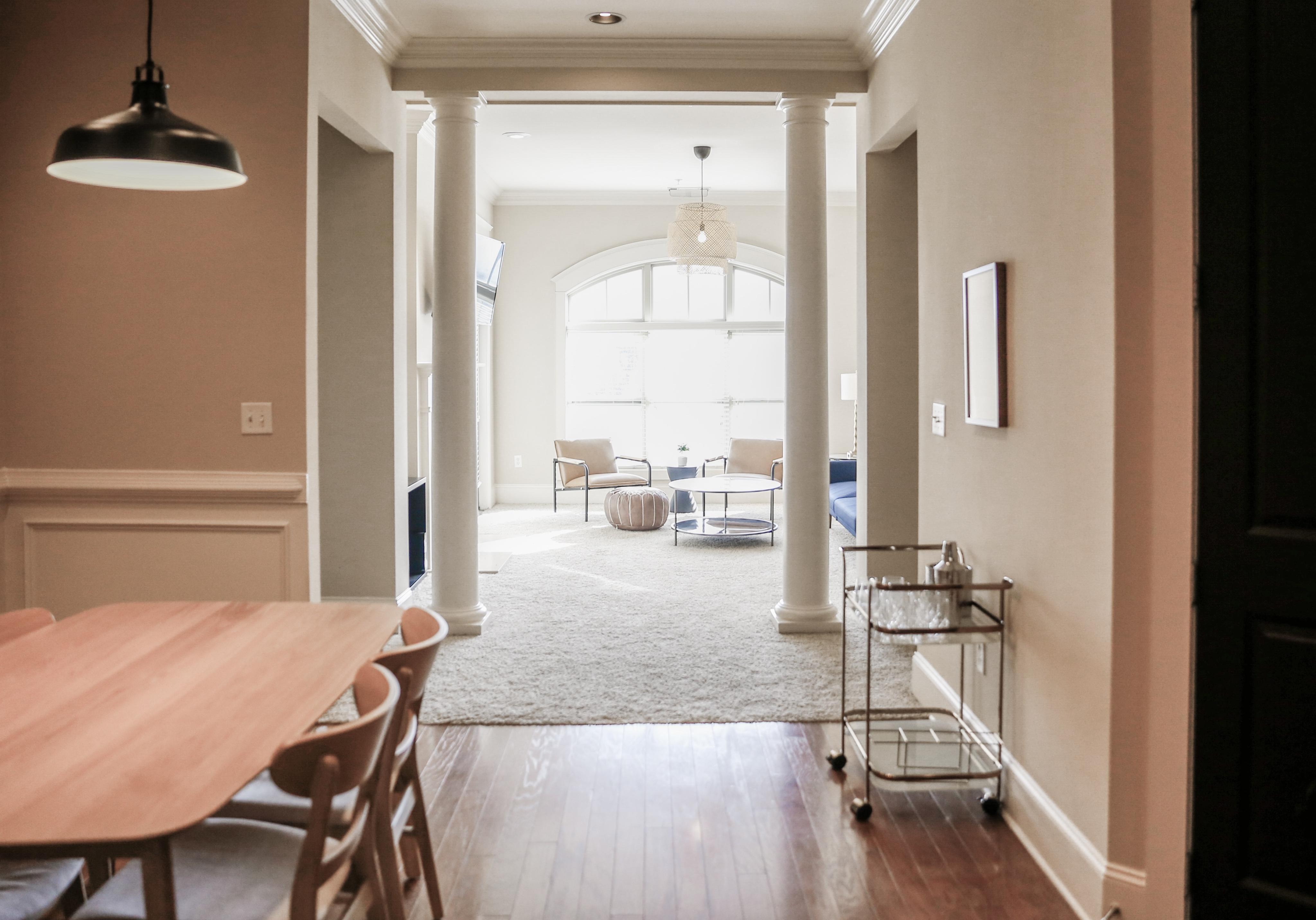 Bright and modern open-concept layout with elegant dining area leading to a cozy living room with natural light.