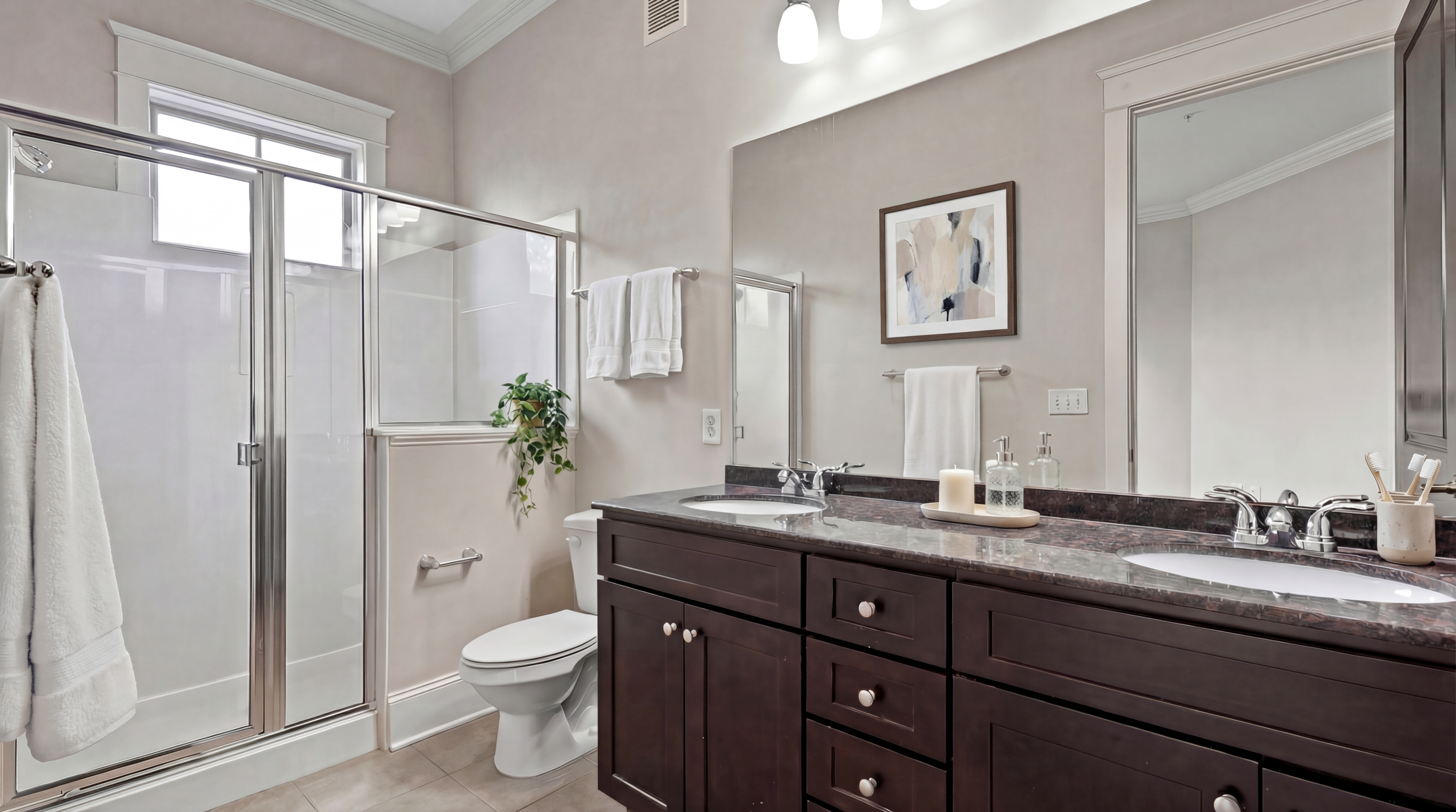 Elegant bathroom with a glass-enclosed shower, modern vanity, and stylish decor for a luxurious living experience.