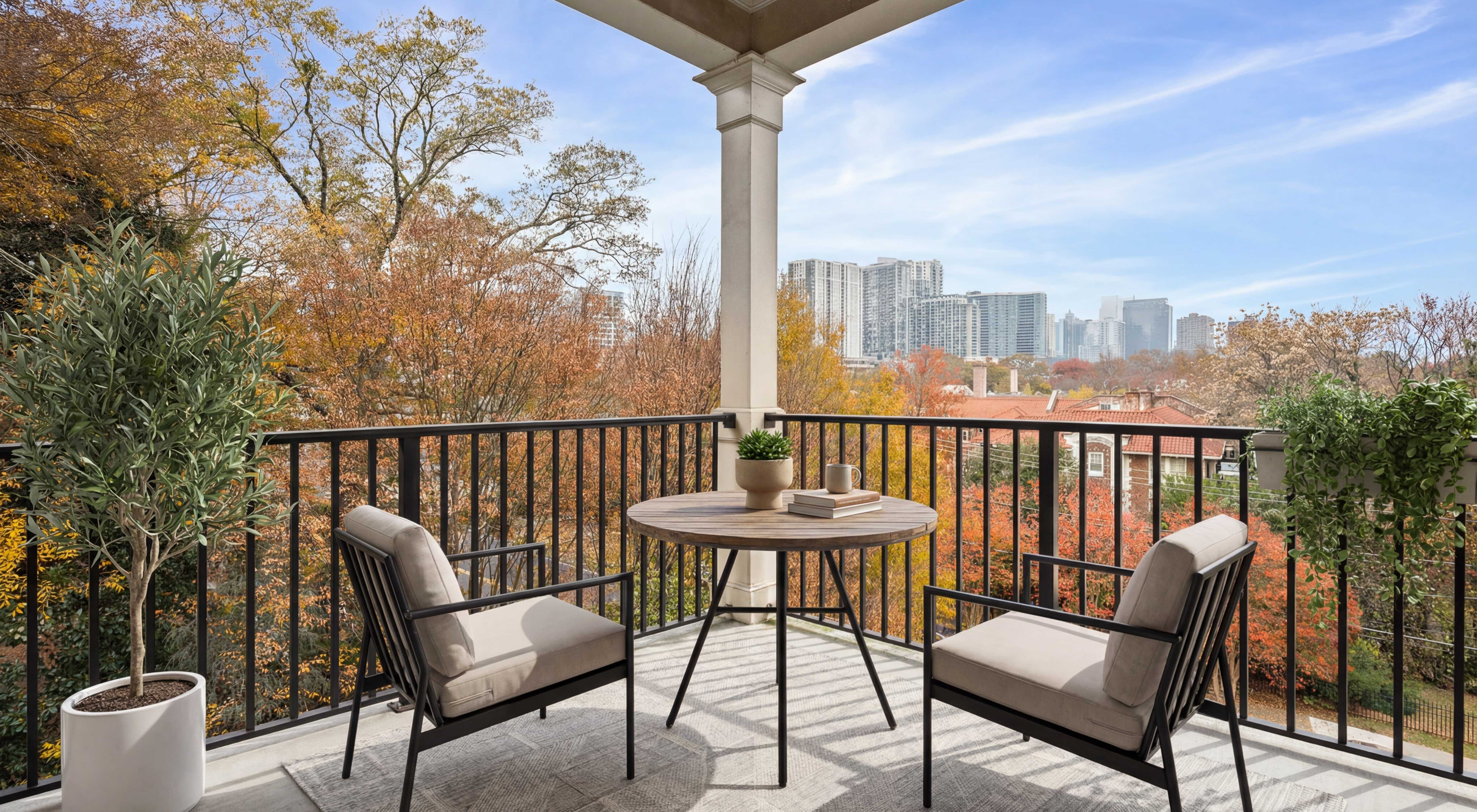 Charming balcony with cozy seating, lush greenery, and scenic city skyline views.