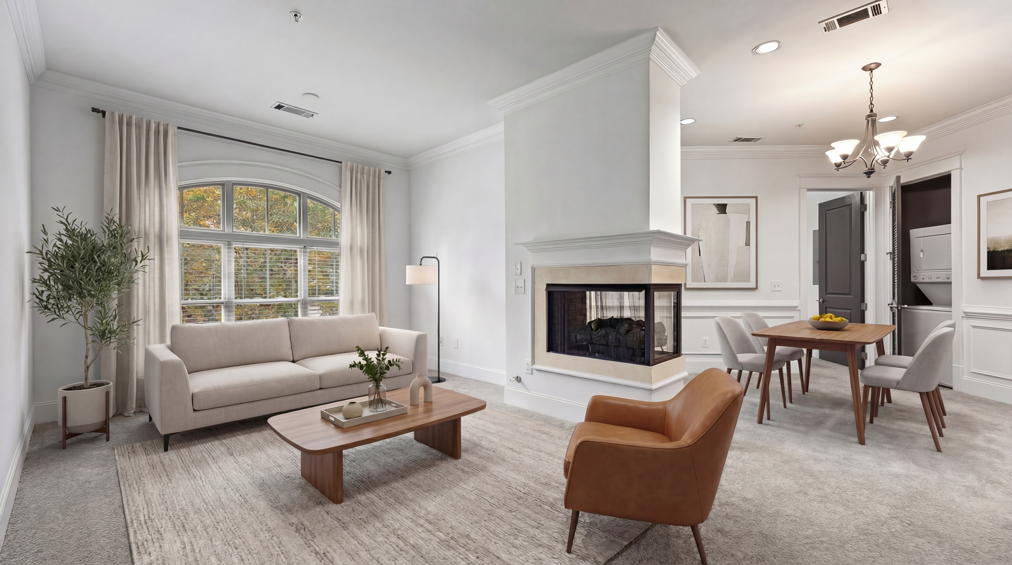 Elegant and cozy living room with modern fireplace, plush seating, and stylish dining area, bathed in natural light from large windows.