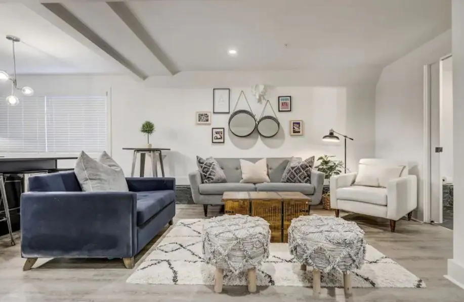 Contemporary living room with chic decor, featuring plush seating, modern lighting, and stylish wall art.