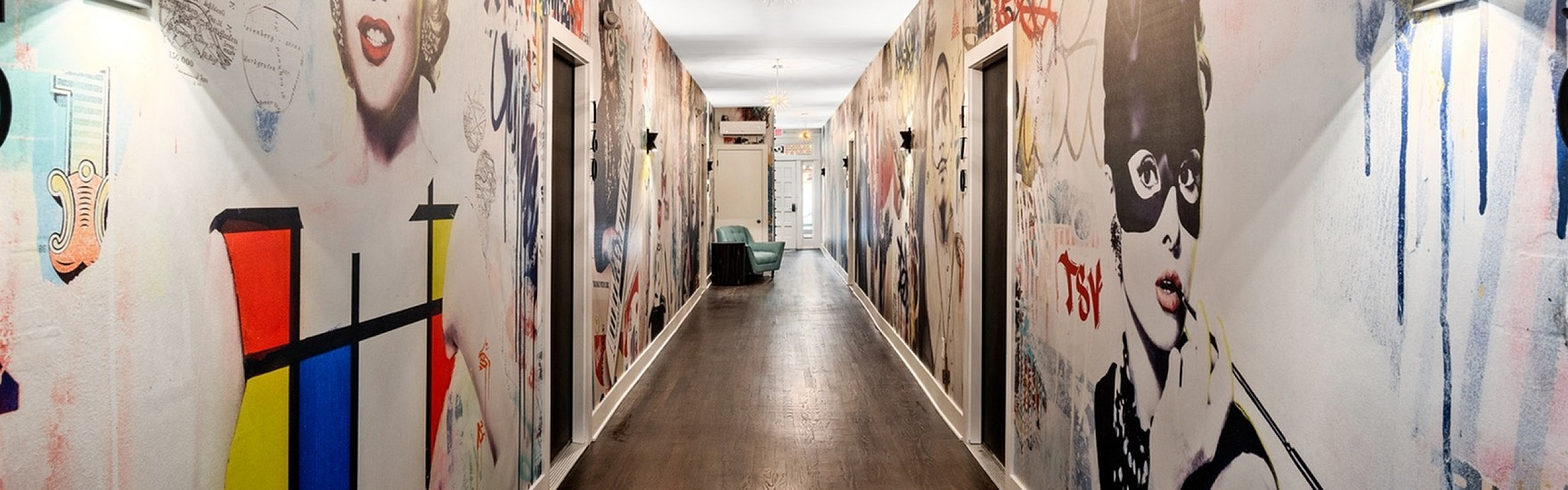 Vibrant hallway with artistic murals featuring iconic pop culture imagery and modern flair.