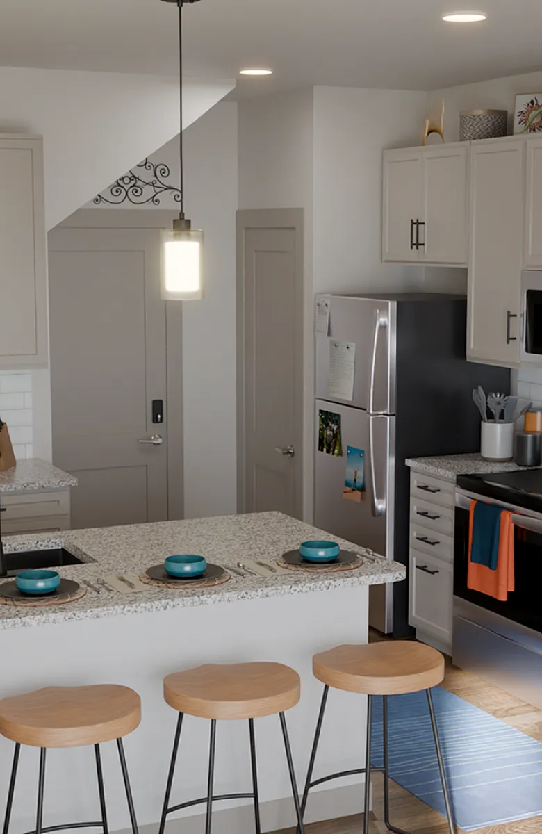 Modern kitchen interior with sleek white cabinets, stainless steel appliances, and a stylish granite countertop breakfast bar with wooden stools.